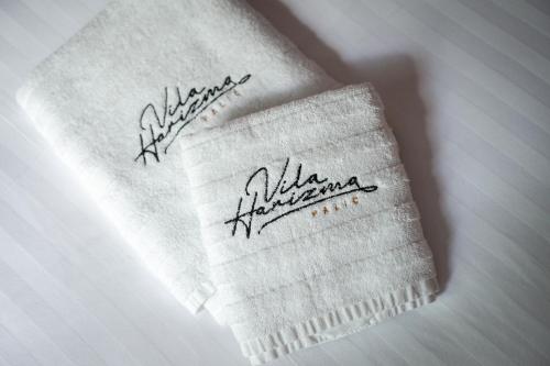 a towel with writing on it on a table at vila Harizma in Palić