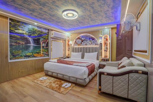 a bedroom with a bed and a painting on the wall at Hotel Premium Suites-Free Airport Pickup in New Delhi