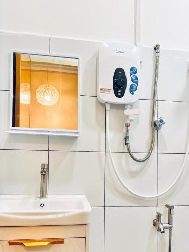 a bathroom with a shower and a sink at Camp Fire Homestay 2601 in Mersing