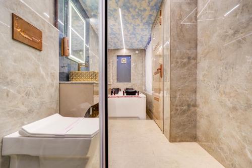 a bathroom with a toilet and a shower and a sink at Hotel Premium Suites-Free Airport Pickup in New Delhi