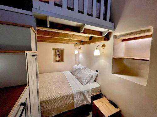 a small bedroom with a bed in a small room at Patossa in Chios