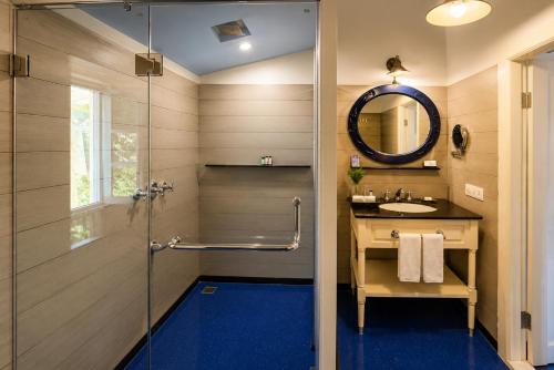 a bathroom with a shower and a sink at Pine Retreat - A Premium Heritage Property in Mussoorie