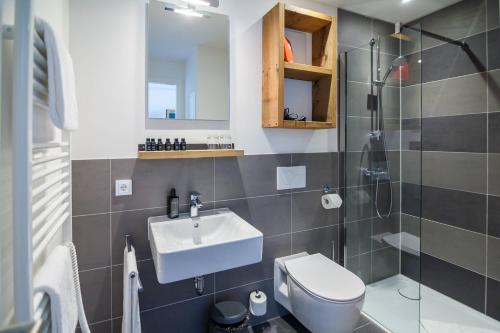 a bathroom with a sink and a toilet and a shower at Staycity Aparthotels Dresden City Centre in Dresden