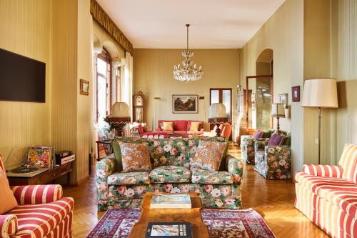 a living room with couches and a table at Villa Jolanda, a Garamonds Property in Brunate