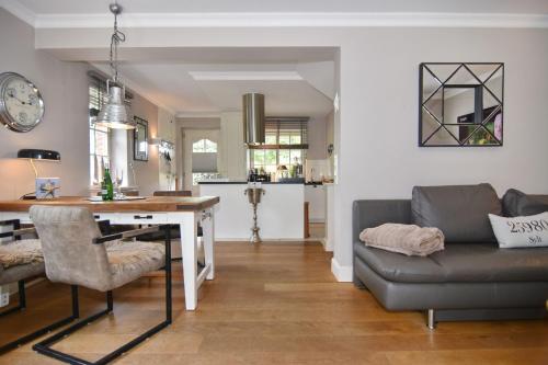 a living room with a couch and a table at Gartenweg 9, Whg Oland in Tinnum