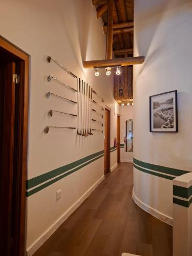 a hallway with green and white stripes on the wall at 19th Hole Golf Villa Guesthouse in Worcester