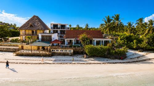 a house on the beach next to the ocean at Malcom Ocean View Retreat in Pongwe
