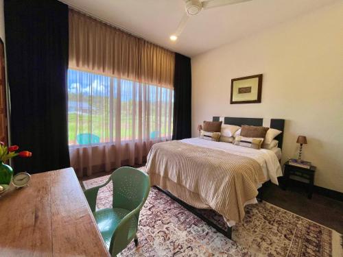 a bedroom with a bed and a large window at Rumah Cermin in Langkawi Intl