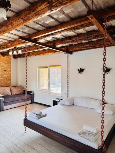 a bedroom with a swing bed in a room at Cottage Hata Zustrich in Bukovel