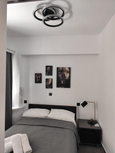 a bedroom with a bed and pictures on the wall at Studio Eleni in Plomari