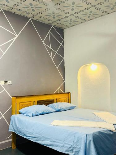 a bedroom with two beds with blue pillows at HELLO MADHi VILLA in Arugam Bay
