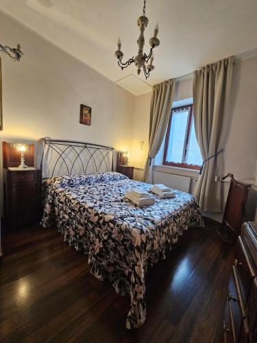 a bedroom with a bed with a floral bedspread at Casina Giulia in Capistrello