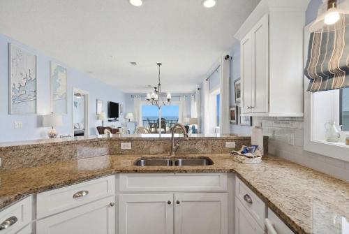a kitchen with white cabinets and a sink at Riviera Dunes 203 in Perdido Key