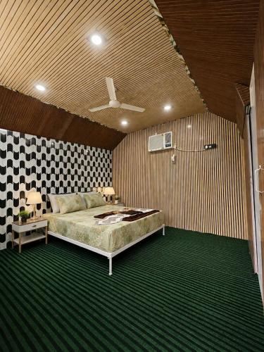 a bedroom with a bed and a checkerboard wall at Shivpuri Ghumakkad Resort in Shivpuri