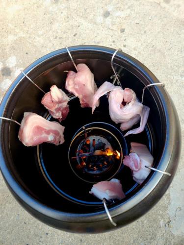 a bowl of food with some meat on sticks at Donghae Mookhoae Pension in Donghae