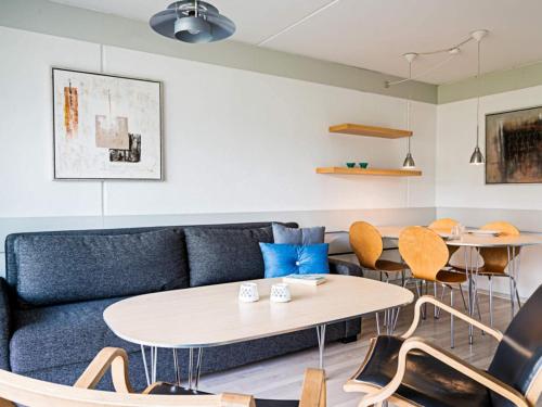 a living room with a couch and tables and chairs at The Apple Garden in Allinge