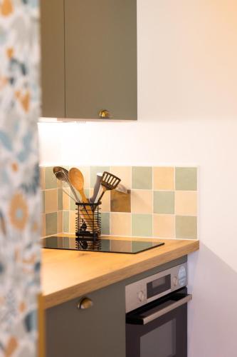 a kitchen with a counter top with a knife rack at Appart'Hôtel & Spa "Les Voiles" Le Groix in Carnac