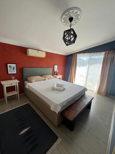 a bedroom with a large bed and red walls at Buena Vista Hotel&Restaurant in Marmaris