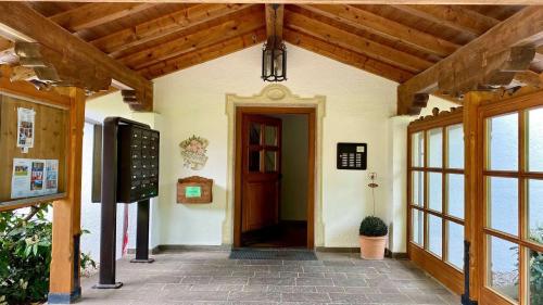 an entrance to a building with a wooden ceiling at FeWo Rottachglück in Tegernsee