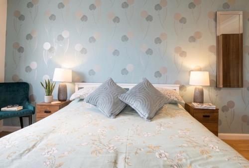a bedroom with a white bed with two pillows at 3 Bed Semi - Sleeps 5 - Private Garden & Parking - Quiet Cul De Sac Location - Dog Friendly - Fast Wifi - Close to Motorway Access in Doncaster