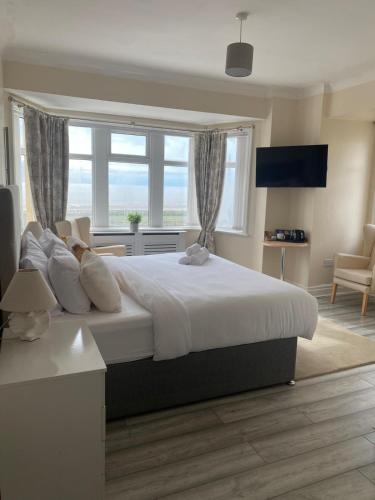 a bedroom with a large bed with a large window at 262 Ocean Manor in Blackpool