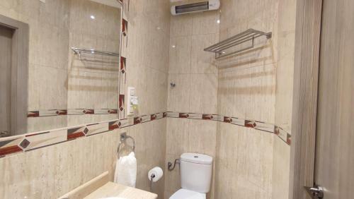a bathroom with a toilet and a sink and a mirror at El Faro-Beach in Cullera