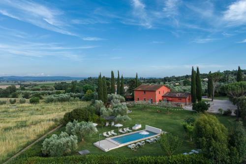 an aerial view of a house in a field with a pool at Zuccherini in Buriano