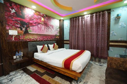 a bedroom with a bed and a painting on the wall at Hotel Royal Sen in Lālbhitti
