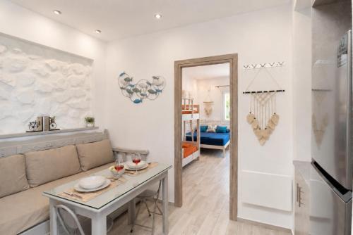 a living room with a table and a mirror at Bella Vista Mare 2 in Moutsoúna