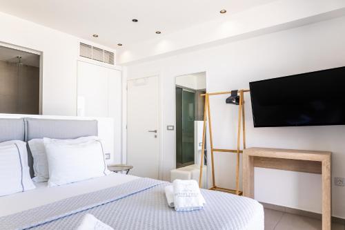 a bedroom with a bed and a flat screen tv at SIVOTA SUNSET VILLAS in Syvota