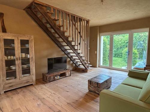 a living room with a spiral staircase in a house at Brühlbach-Blick in Morbach