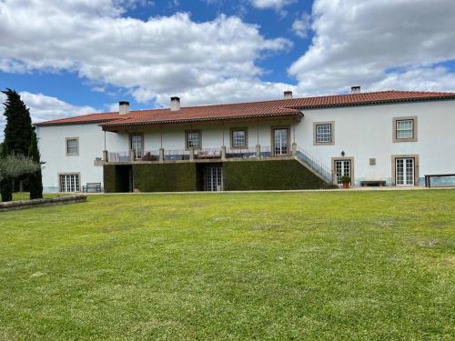 a large white house with a large yard at 199 - Quinta dos Carvalhos in Castelo Branco