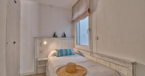 a bedroom with a bed with a hat on it at Llafranc Centre, Totally Refurbished in Llafranc