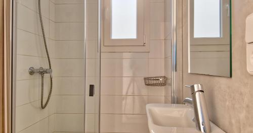 a bathroom with a shower and a sink at Llafranc Centre, Totally Refurbished in Llafranc