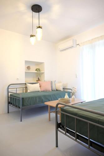 a living room with a bed and a table at MarGo House Kythnos in Kithnos