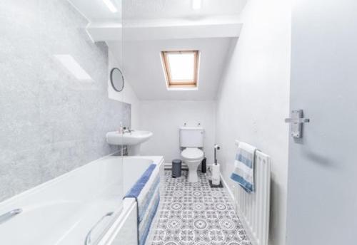 a bathroom with a tub and a toilet and a sink at Egremont Hide Away - Perfect contractor accommodation - Close to Sellafield in Woodend