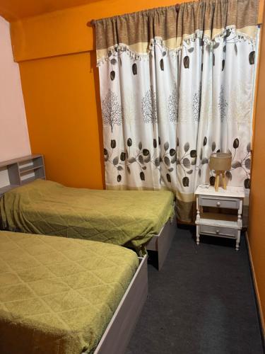 a room with two beds and a curtain at La Mary duplex in Federación