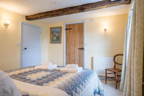 a bedroom with a bed with two towels on it at The Light House, Southwold in Southwold