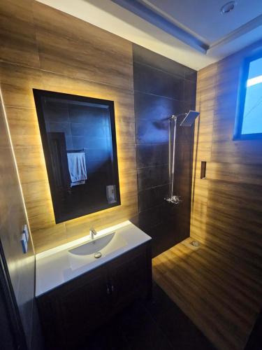 a bathroom with a sink and a shower at The Terraces by 12th Avenue in Murree