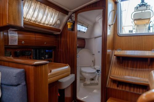 a small bathroom with a toilet and a sink at Yacht Pipit - Unique Stay in Marina of Kavala in Kavála