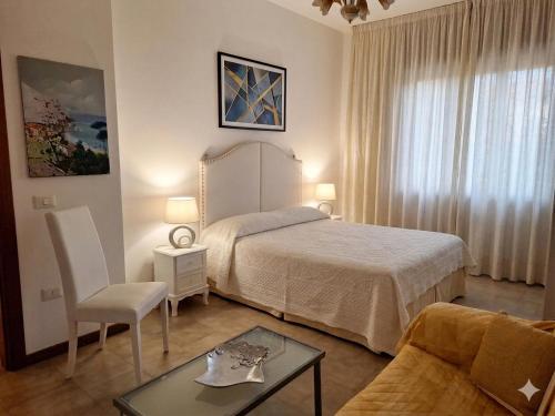 a hotel room with a bed and a table at Villa Ida in Capo Rizzuto