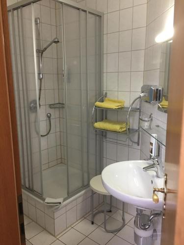 a bathroom with a shower and a sink at Hotel & Restaurant Park Cafe ISA in Erfurt