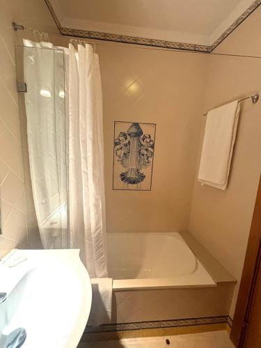 a bathroom with a bath tub and a toilet at CASA DA VILA 2, Sintra in Sintra