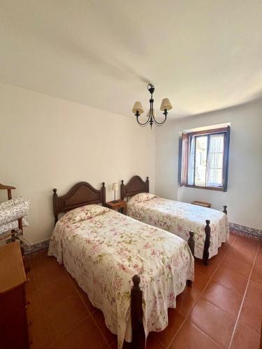 a bedroom with two beds and a window at CASA DA VILA 2, Sintra in Sintra
