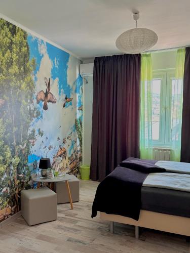 a bedroom with a bed and a colorful wall at Sarajevo, Stari Grad, Apartment in Sarajevo