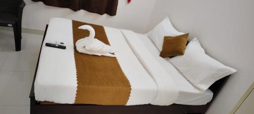 a bed with a swan decoration on it at Twin Tag Residency in Chennai