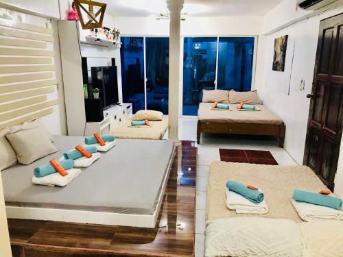 a living room with several beds and a couch at Manzanares Homestay in San Jose