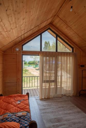 a bedroom with a large window and a bed at Noygut in Dzhetyoguz