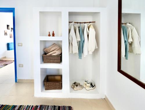 a room with white shelves and a mirror at Amnesia Residence in Naama Bay - Downtown in Sharm El Sheikh
