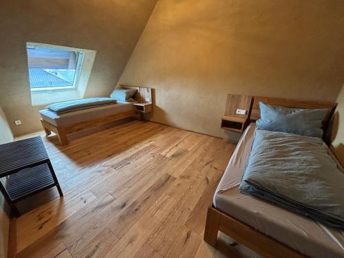 a bedroom with two beds and a window at Erbeskopf Gipfelquartier in Morbach